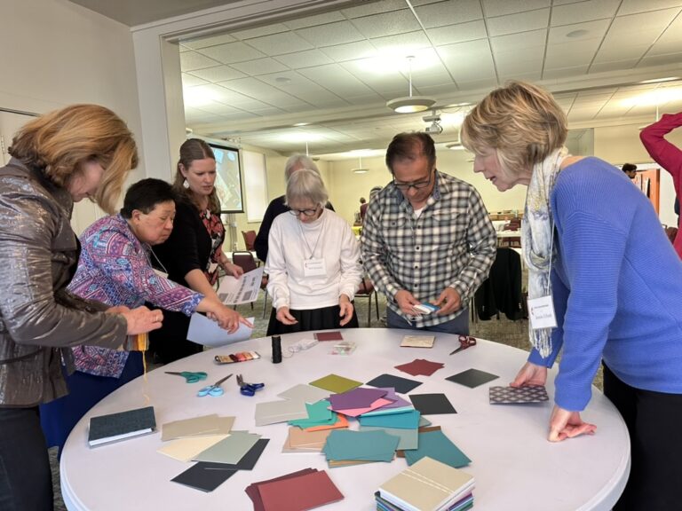 Group of people working on crafts together at a table