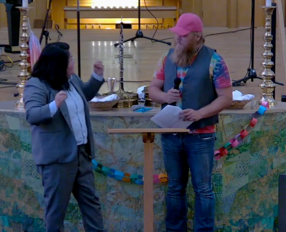 Lynnette and Travis speaking in front of the altar