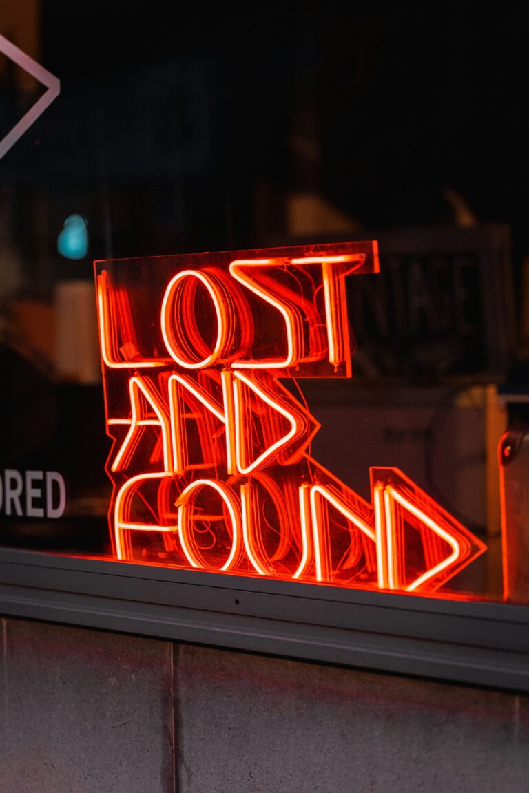 Neon sign in a store window reading "Lost and Found"