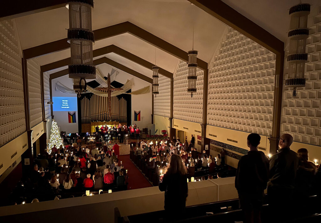 Candlelight services in sanctuary with people as viewed from the balcony.