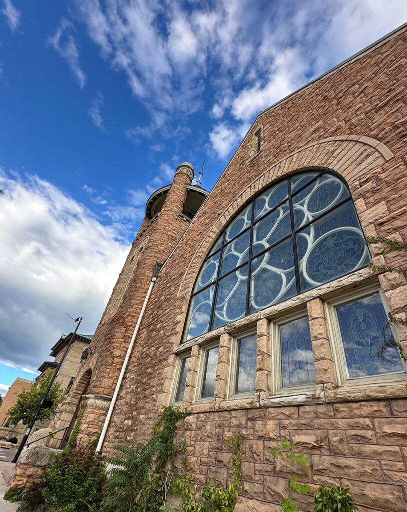 FUMC stone exterior with large glass rounded window