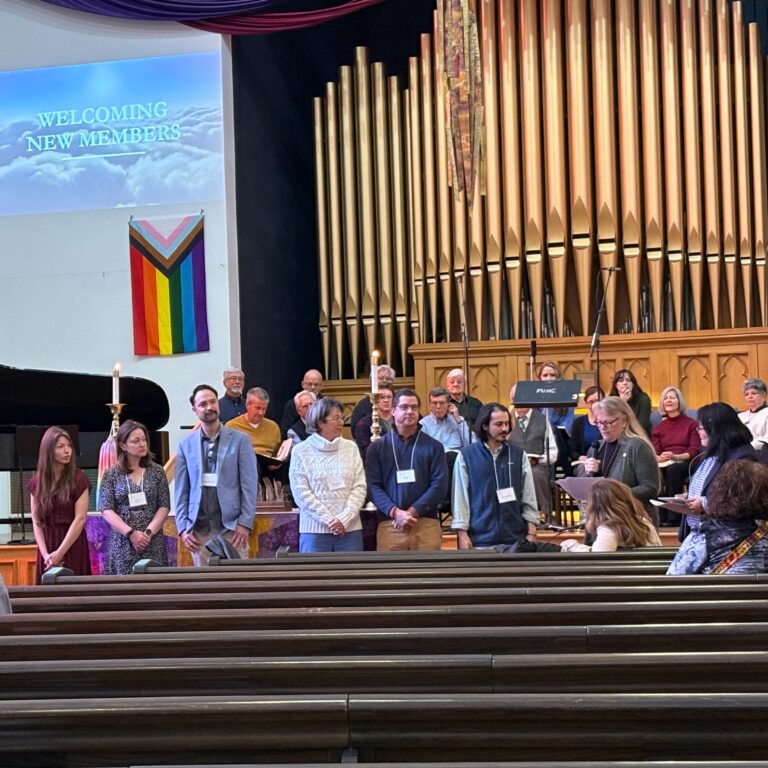 New members at the front of the church being introduced to the congregation