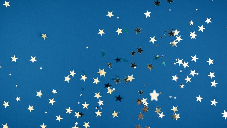 Gold star confetti on a blue background